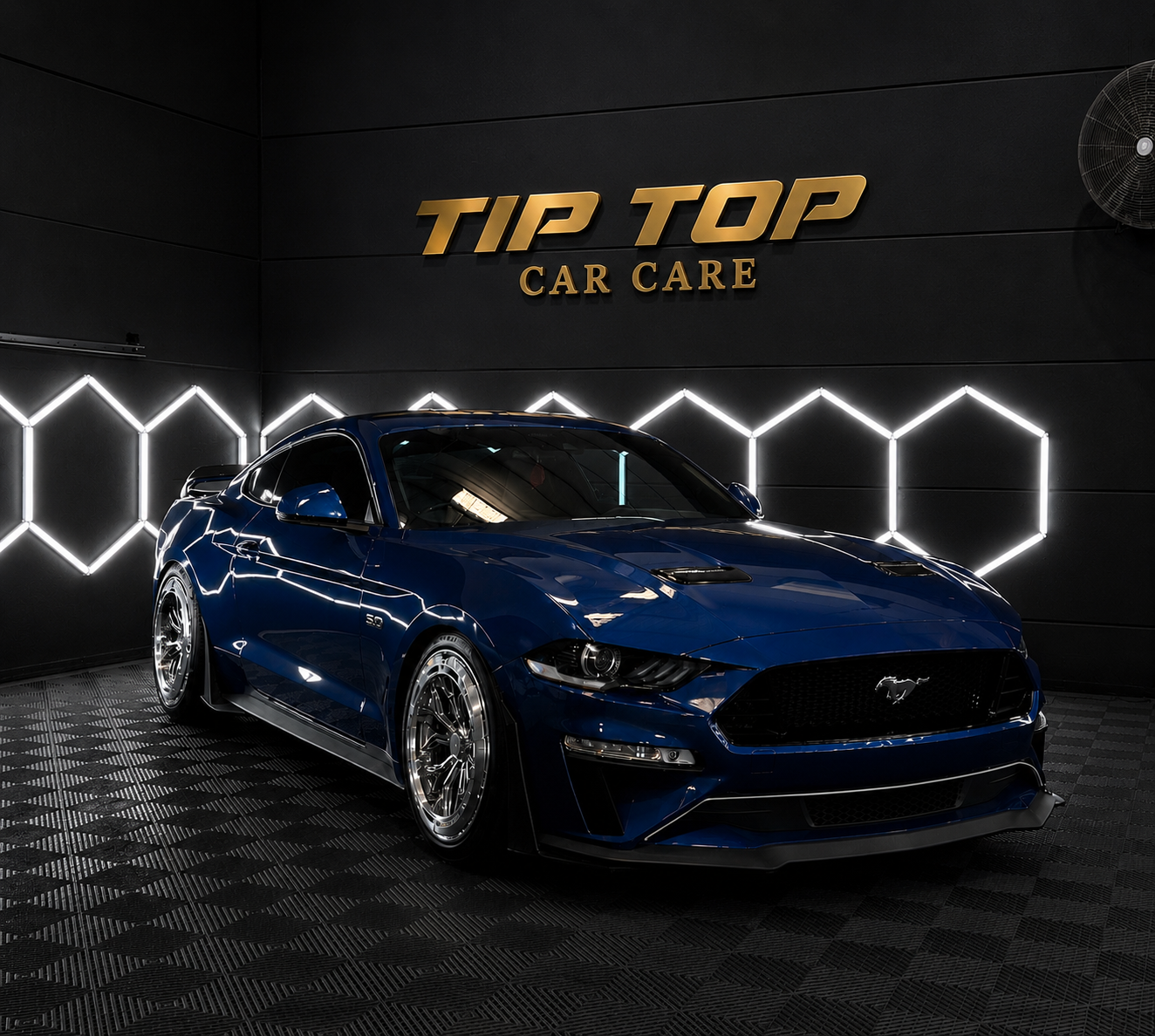 Tip Top Car Care studio with a detailed Mustang under the gold Tip Top signage